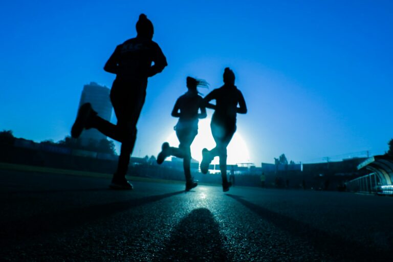 Silhouette of three runners training together