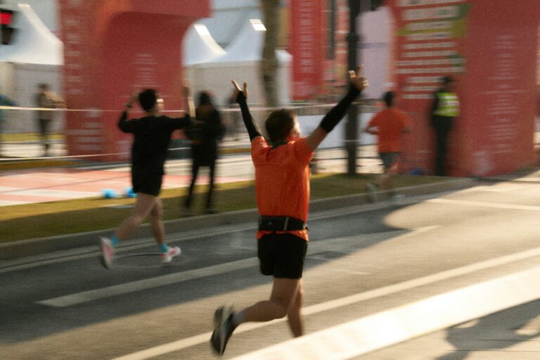 Runner celebrating crossing the finish line at a marathon